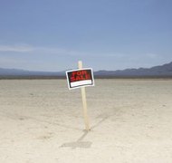 Chris Clinton/Stockbyte/Getty Images Selling your inherited land can take a long time if it isn't marketed properly.