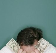 Comstock/Comstock/Getty Images Marital debt isn't relieved by a divorce.