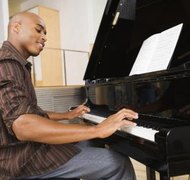 Jupiterimages/Creatas/Getty Images Playing a song at a meeting can potentially breach copyright laws.