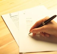 Hemera Technologies/AbleStock.com/Getty Images Your agent may sign financial papers for you.