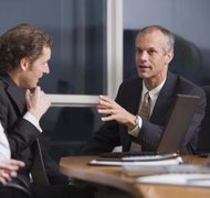 Jupiterimages/Comstock/Getty Images Business owners weigh the pros and cons of business structures when forming a new company.