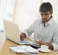 Flying Colours Ltd/Photodisc/Getty Images Pay stubs aid in determining your child support payments.
