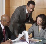 Digital Vision/Photodisc/Getty Images A QDRO divides employer-provided retirement plans between divorcing couples.
