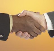 Hemera Technologies/AbleStock.com/Getty Images A partnership agreement can specify profit distribution.