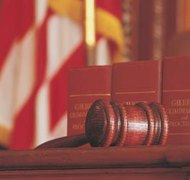 Comstock/Comstock/Getty Images Enforcing court orders requires the aggrieved party to file a contempt motion.