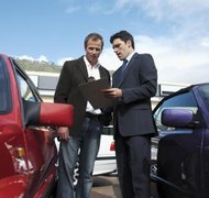 Stockbyte/Stockbyte/Getty Images You can obtain power to sign a vehicle title for someone else.