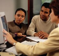 Keith Brofsky/Photodisc/Getty Images One spouse generally must refinance to remove the other's name.
