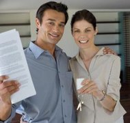 Jupiterimages/Pixland/Getty Images A house with a mortgage can be owned by a trust.