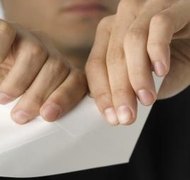 Medioimages/Photodisc/Photodisc/Getty Images Tearing is one method of revoking a will.