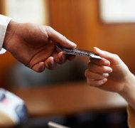 Rayes/Photodisc/Getty Images An agent under a power of attorney document can legally obtain a debit card in your name.