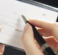 Hemera Technologies/AbleStock.com/Getty Images In Alabama, parents often send support checks to the state for distribution.