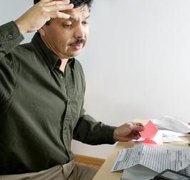 Jupiterimages/liquidlibrary/Getty Images Calculating LLC member compensation can be complicated.