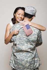 Jupiterimages/Creatas/Getty Images A power of attorney allows you to act on behalf of your deployed spouse.
