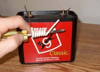 Wire-wrapped screwdriver and battery.