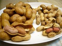 Boiled peanuts next to uncooked peanuts