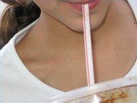 Woman Sipping from a Straw
