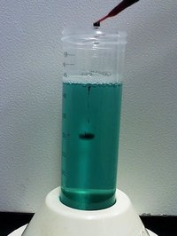 A drop of blood sinking in a tube copper sulfate.