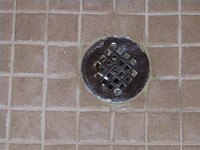 http://dailyhomerenotips.com/wp-content/uploads/2008/03/resealed-shower-drain-cap.jpg
