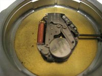 Open watch cover showing location of battery with positive terminal on top