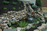 A completed hillside water garden with waterfall
