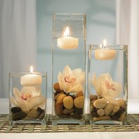 Candles, stone and vases help in creating beautiful outdoor wedding table decorations