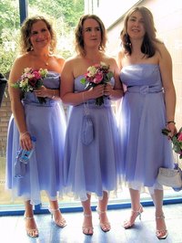 Bridesmaids in tea-length gowns.
