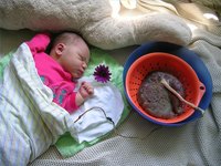 Hours-old infant with placenta and cord still attached
