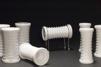 Attach the loose hair rollers to a pyramid constructed from sandpaper and wire.