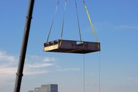 A pallet with a truss attaches to the hoist pulleys.