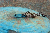 An overturned garbage can lid makes a cheap and effective birdbath.