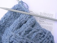 Knit a lap robe to help someone stay warm.