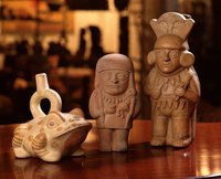 Inca-style clay figures of a frog and two men.