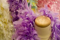 Attach feather boas to a child's dance costume with basic sewing supplies.