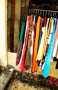 Dress up freestanding clothing racks to make them part of a room's design.