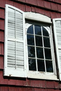 Wooden shutters with peeling paint.