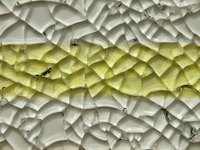 Tempered glass is intentionally shattered in a systematic way for use in mosaic art.