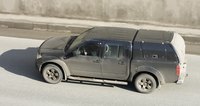 A pickup truck with a camper creates a covert campsite.