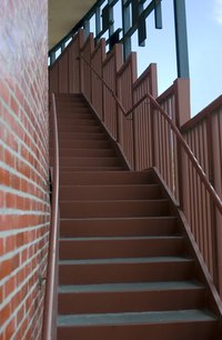 Exterior stairs along a brick wall.