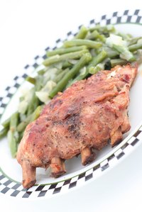 Serve BBQ ribs with vegetables and potato for a complete meal.