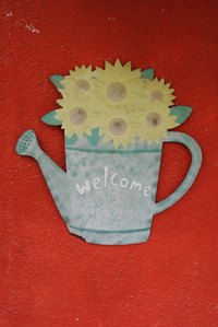 Hand paint a wood sign with freestyle or stenciled letters and designs.