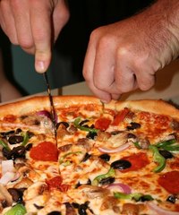 Keeping the pizza stone cleaned and flouring the finished dough will help keep items from sticking.