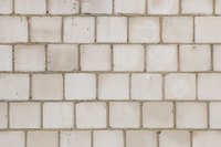 A solid retaining wall can be built from cinder block and filled with concrete.
