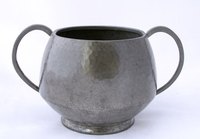 This sugar bowl is made from pewter; if an arm happens to bend, it is easily fixed.