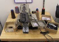 Industrial sewing machine being repaired.