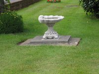 Add a bird bath to an area of your yard where grass won't grow.