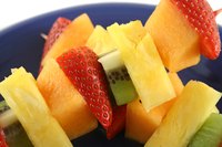 Fruit on skewers with yogurt dip gives guests something to nibble on as they circulate.