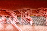 This loom makes rugs 28 inches wide; set up fewer warp strings for smaller rugs.