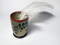 A quill pen made from a feather.