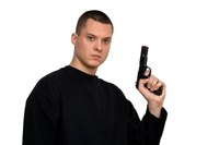 Adding a fake handgun to the costume lends a more realistic touch.