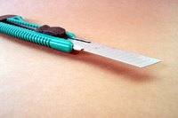 A utility knife will allow you to make precise cuts in the stencil